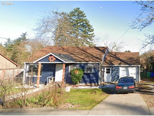 a front view of a house with a yard fountain and garage