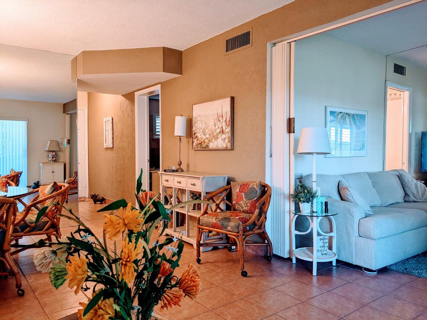 a living room with furniture and a potted plant