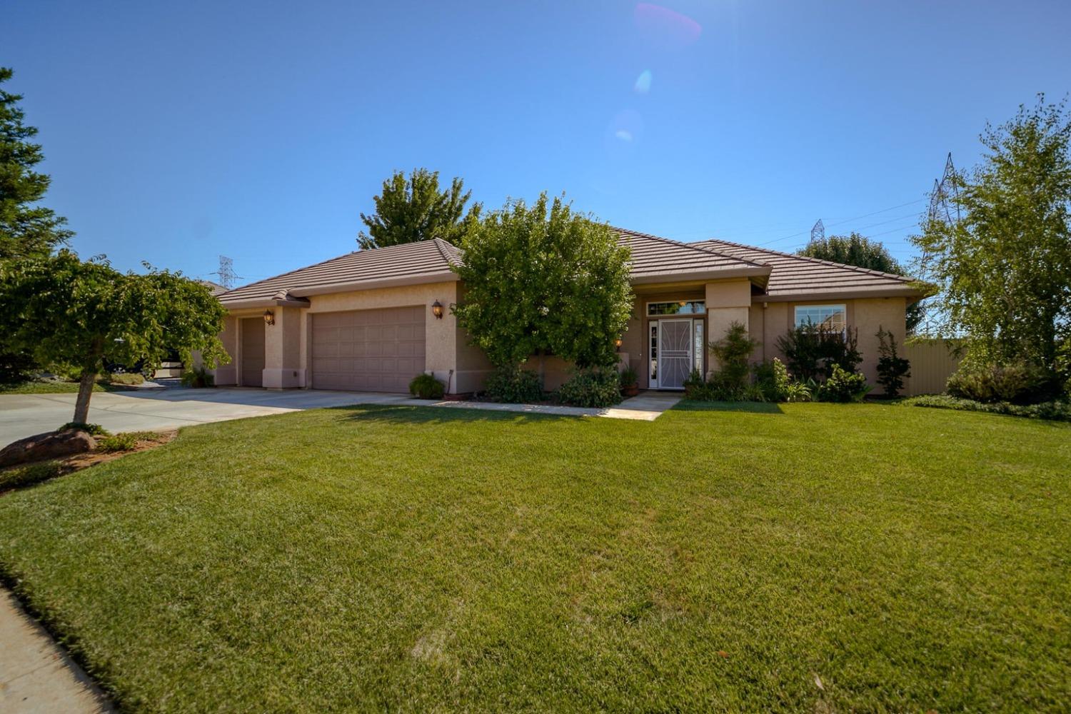 a front view of house with yard and trees