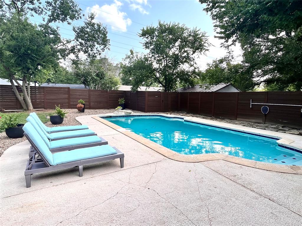 a view of a chairs and tables in the back yard