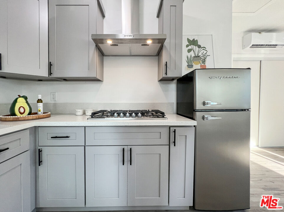 a kitchen with stainless steel appliances granite countertop a refrigerator and a stove