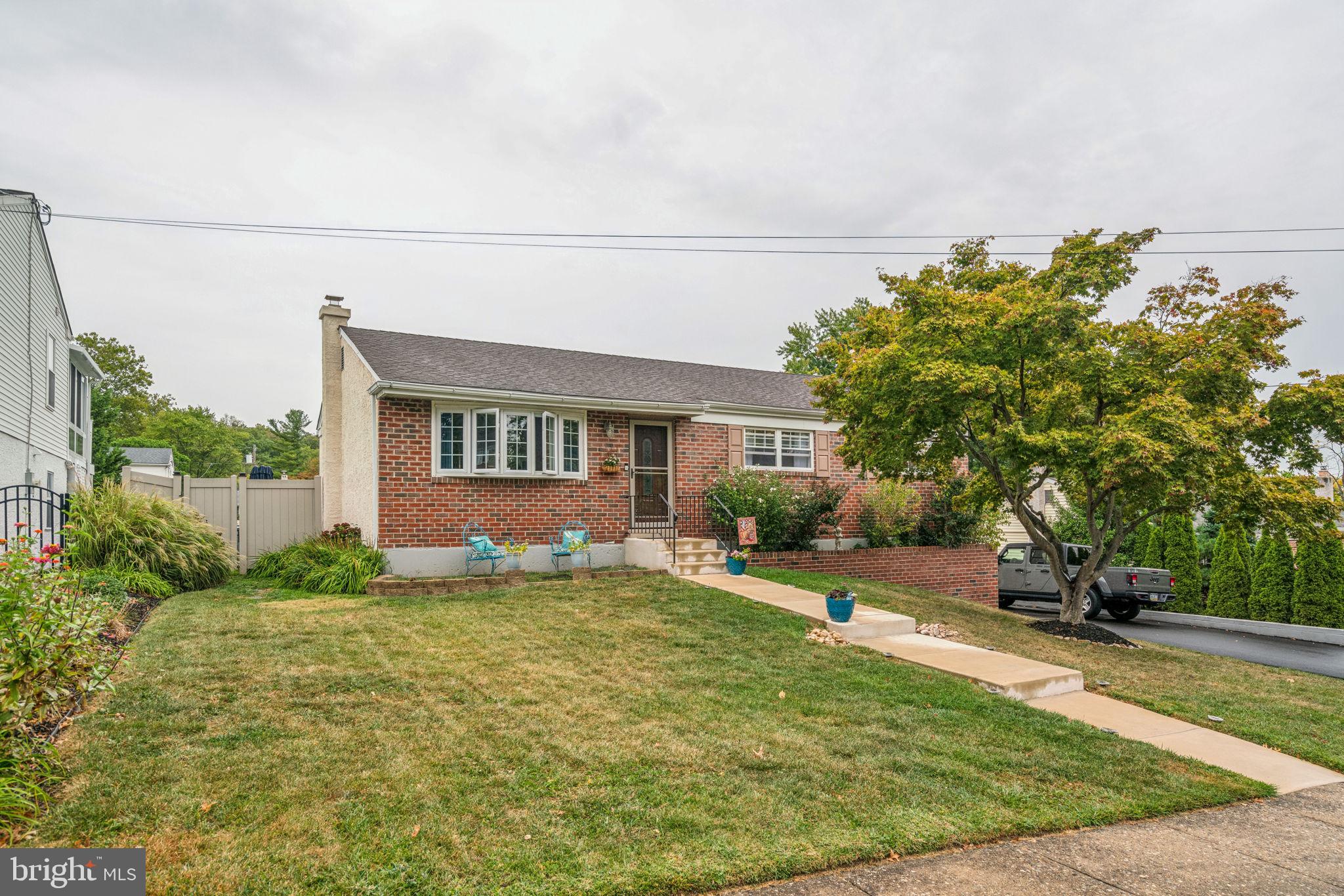 a view of an house with backyard space and sitting area