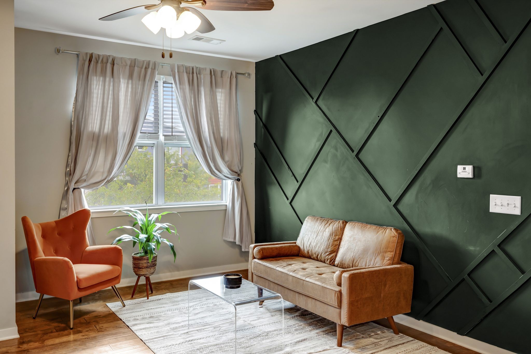 a living room with furniture and a potted plant