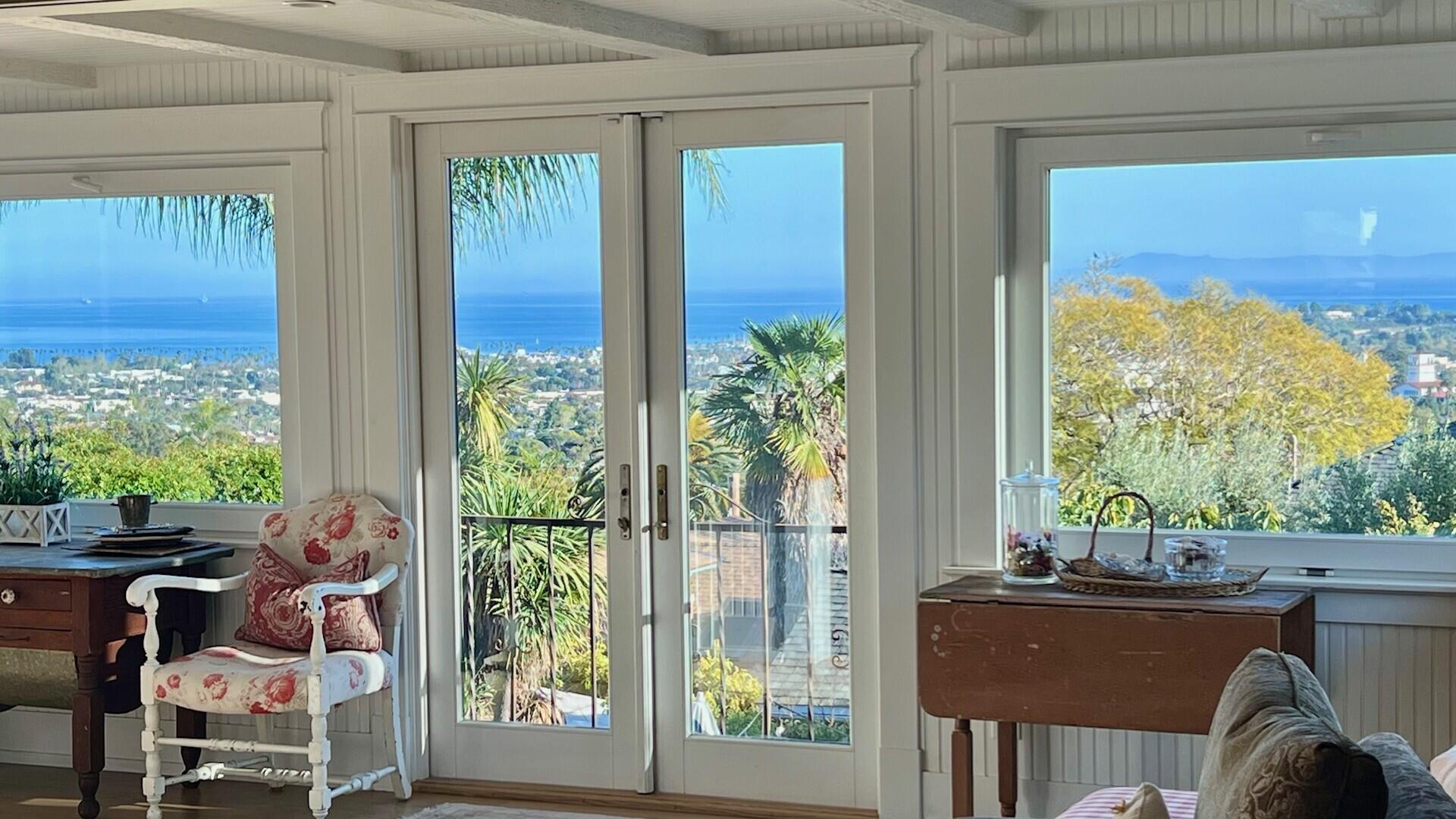 a view of a room with a large window and an outdoor view