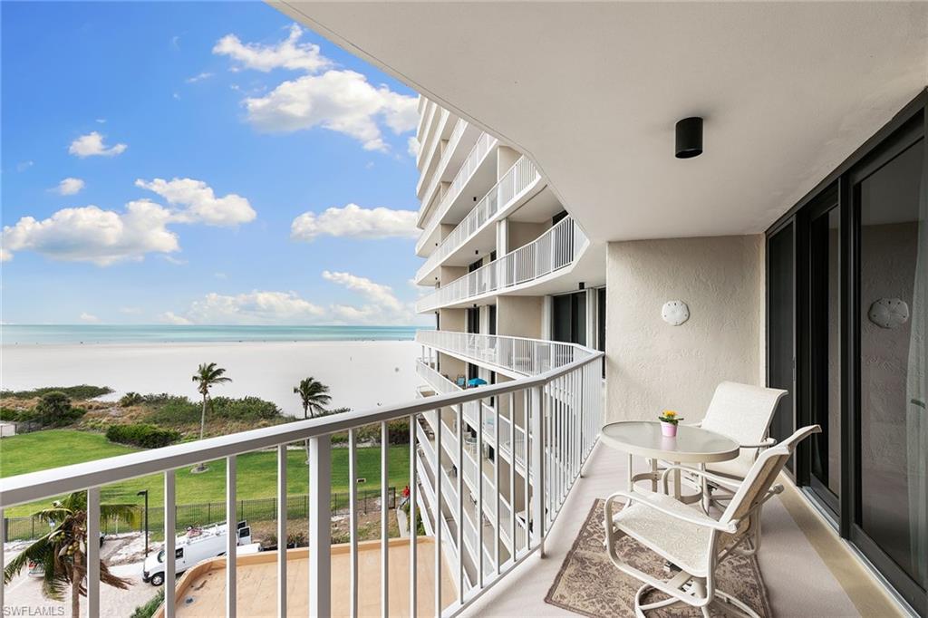 a view of a balcony with furniture