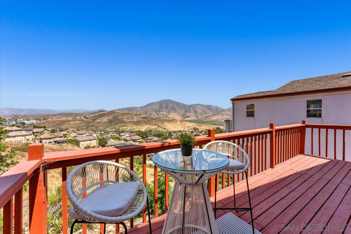 a view of a chairs and table on the roof deck