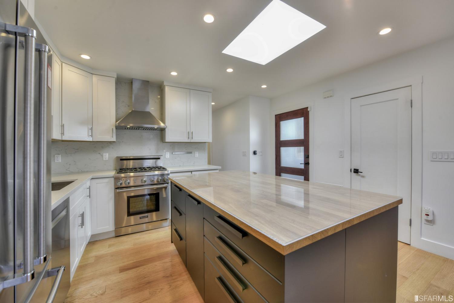 a kitchen with a stove sink and cabinets