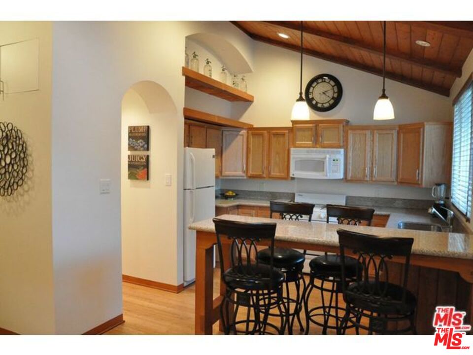 a view of a dining room with furniture and a clock