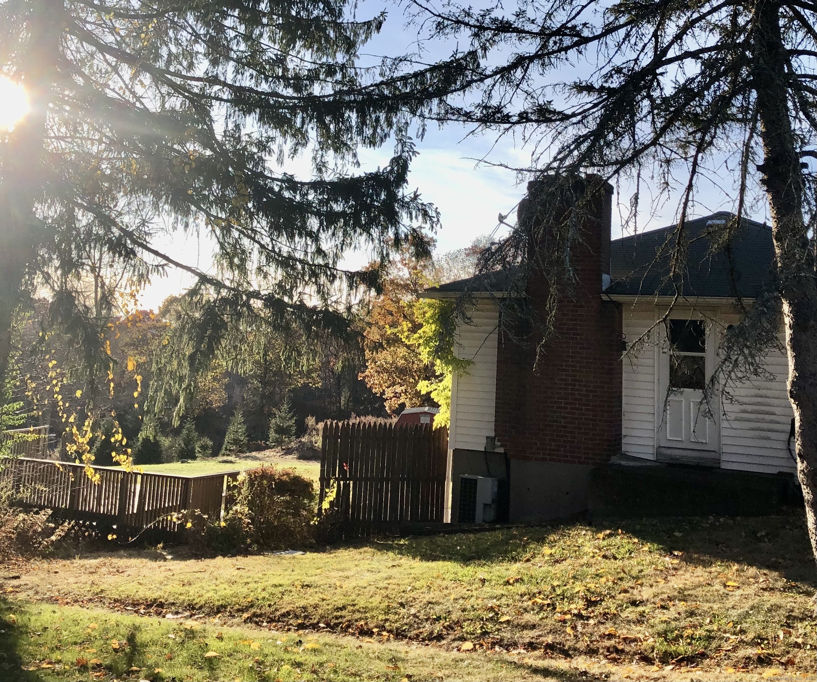 a view of a yard covered with snow in front of house