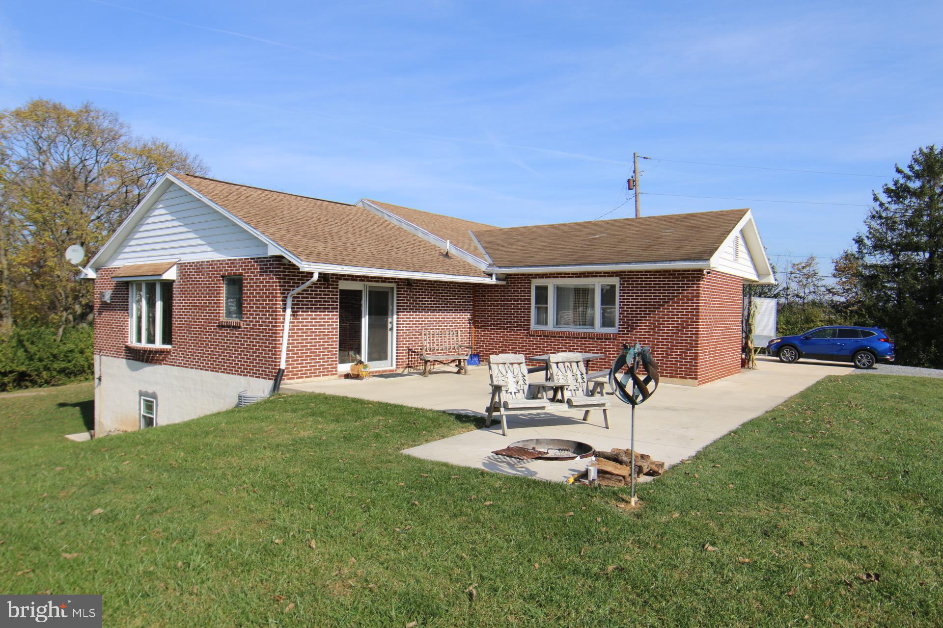 a view of a house with a backyard and a patio