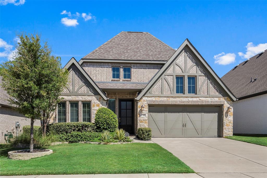 a front view of a house with a yard and garage