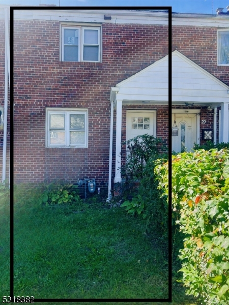 a view of a house with a small yard and plants