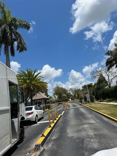 a view of a street with a cars parked