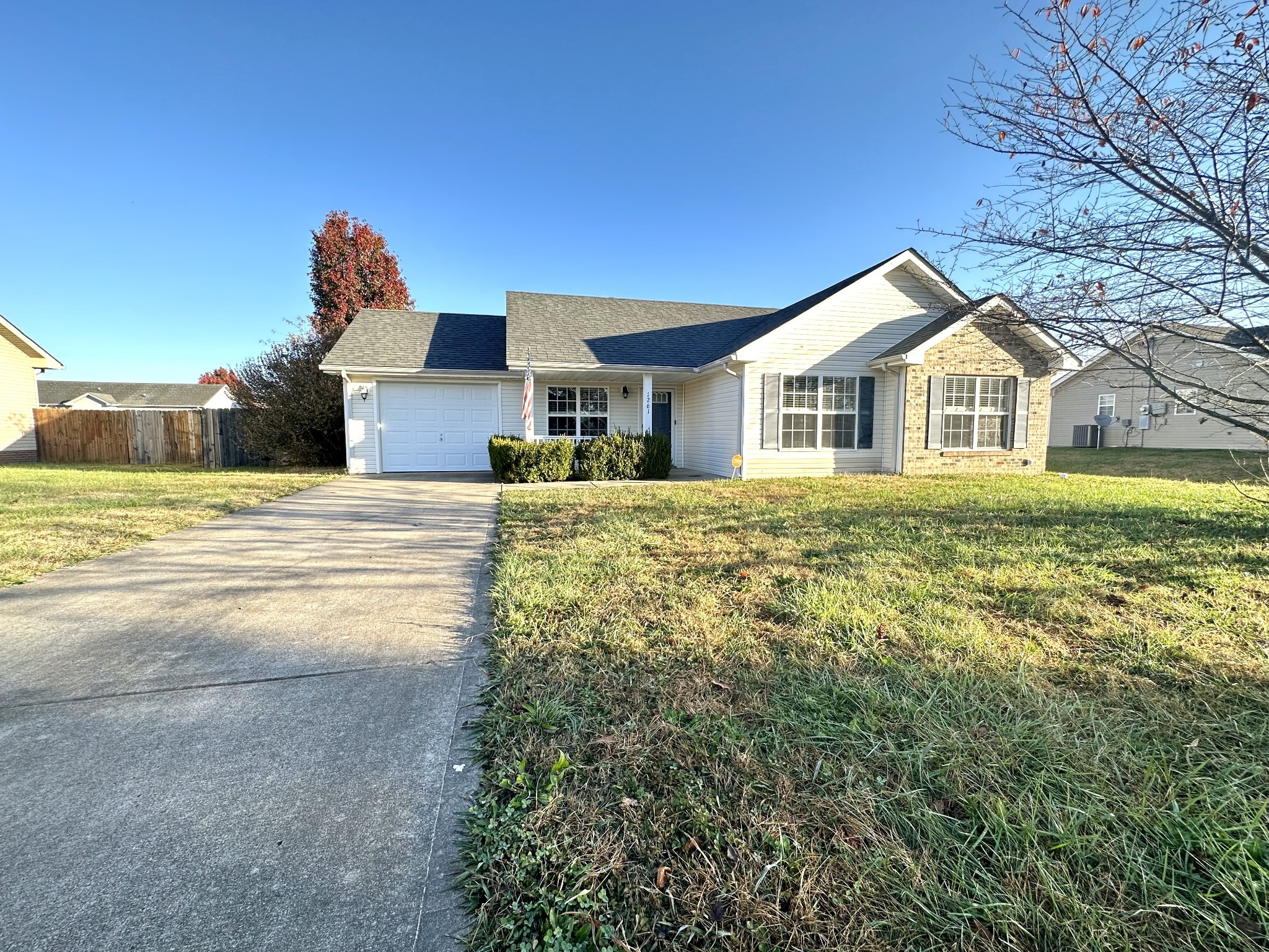 a front view of a house with a yard and trees