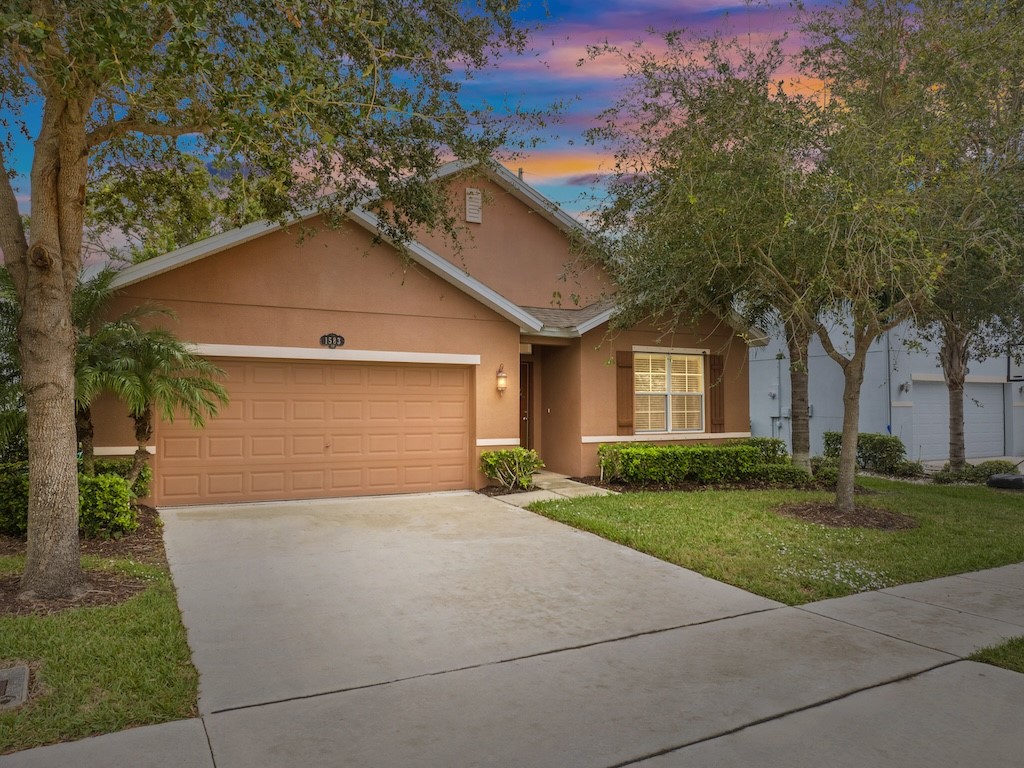 a front view of a house with a yard and garage