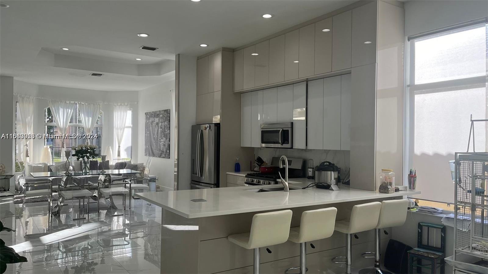 a kitchen with a dining table chairs sink and stove