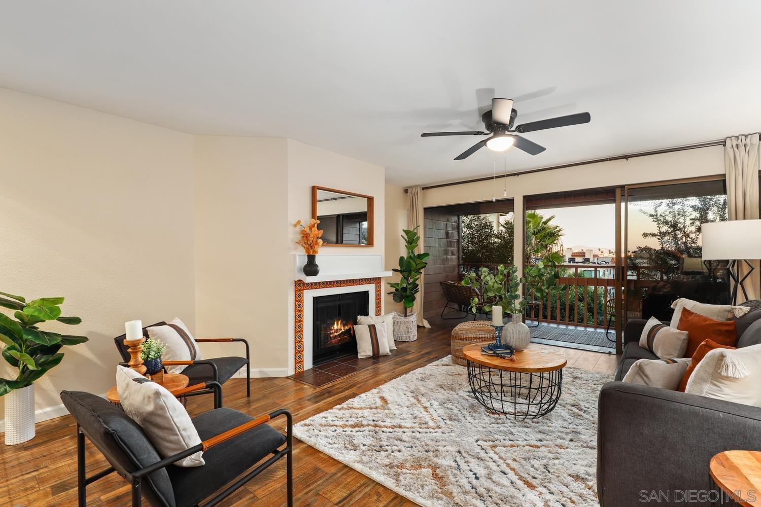 a living room with furniture a table and a fireplace