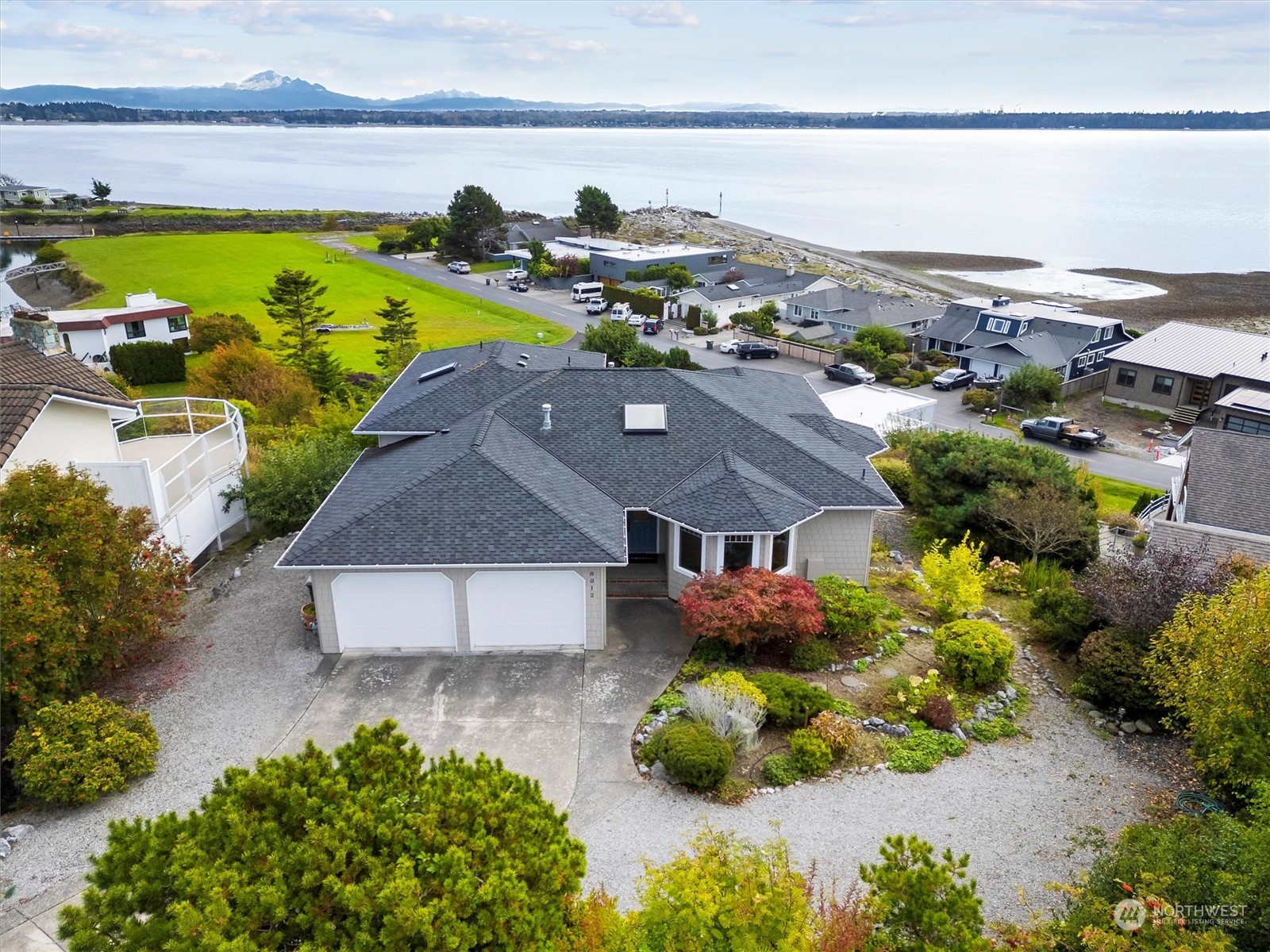 a aerial view of a house with a yard and lake view