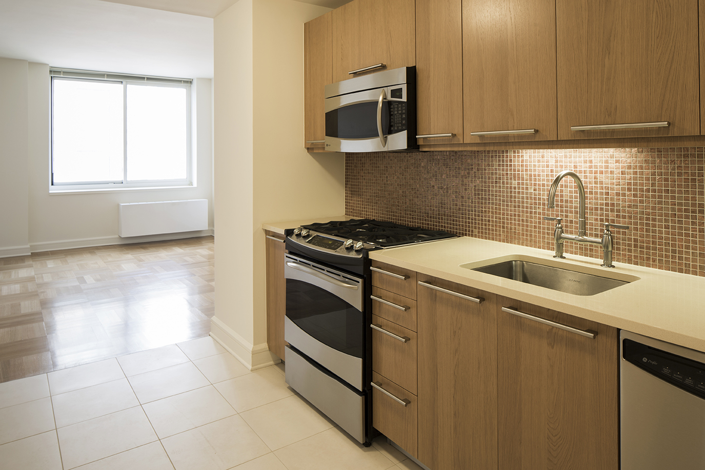 a kitchen with granite countertop a sink and a stove top oven