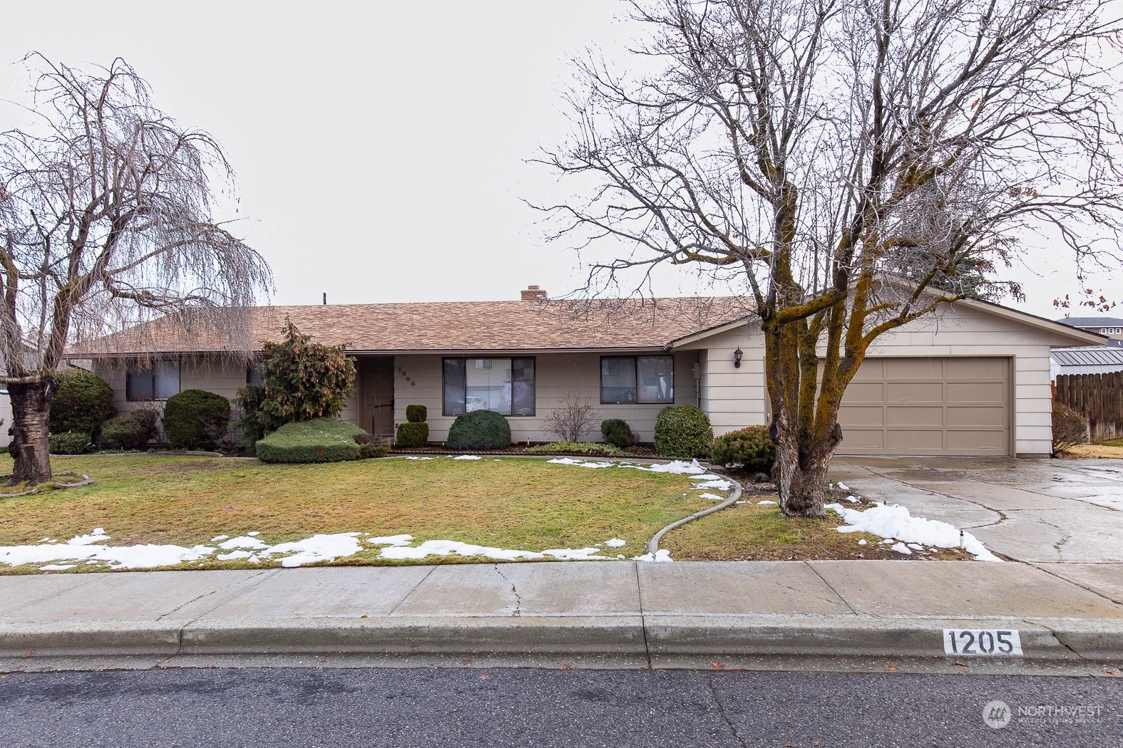 a view of a house with a yard covered in snow