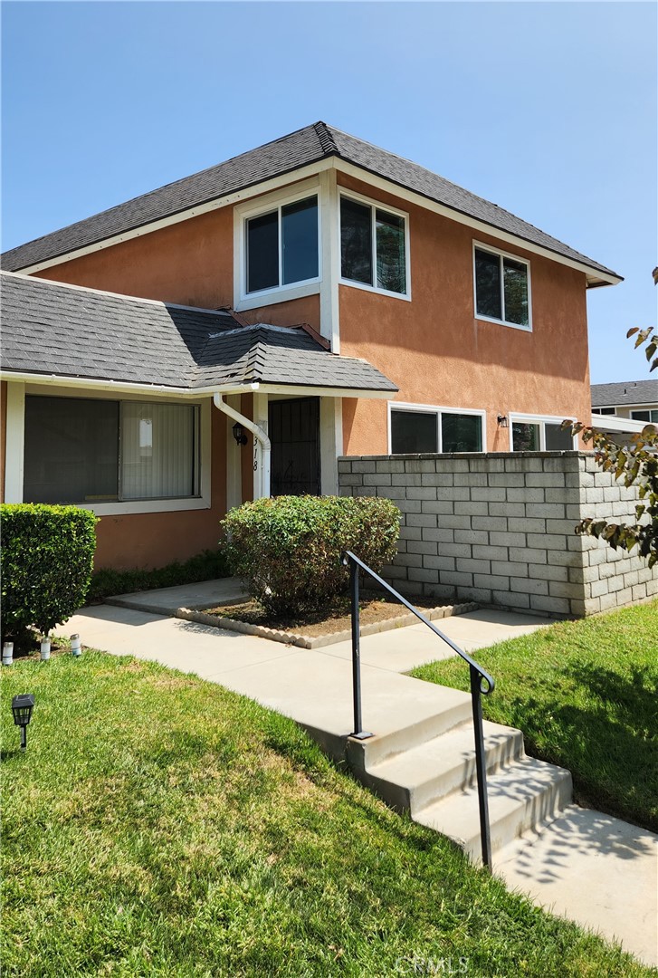 a front view of a house with garden