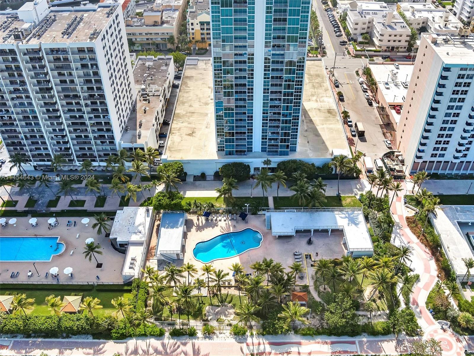 an aerial view of a house with a yard and lake view