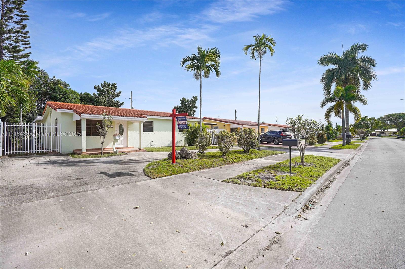 a view of a house with outdoor space and palm trees