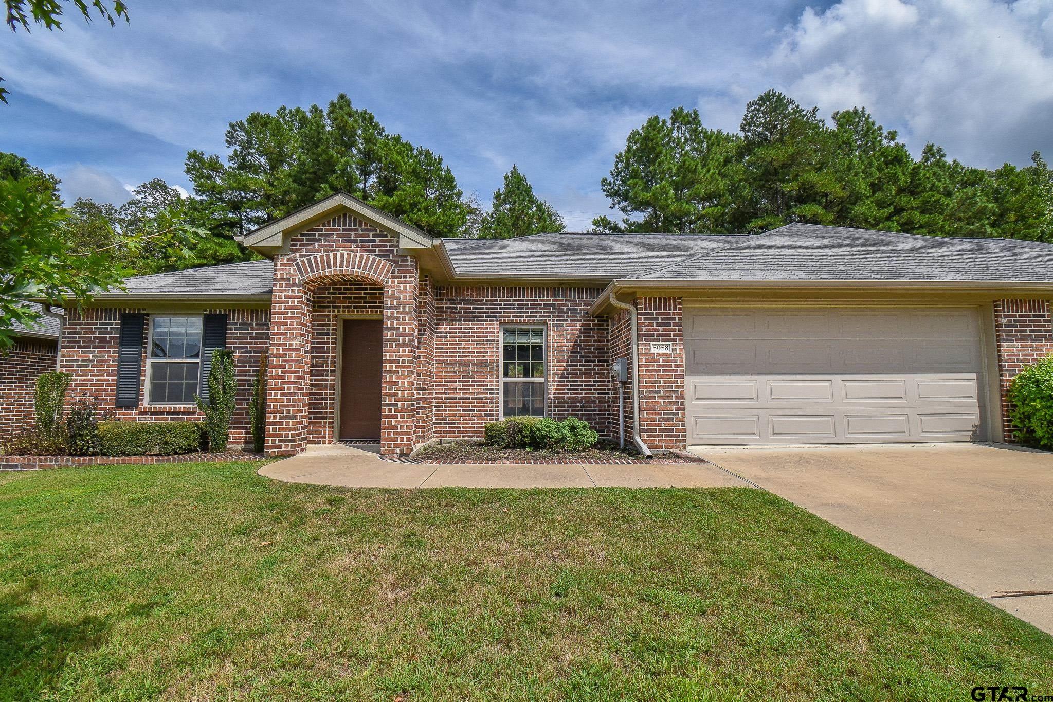 front view of a house with a yard