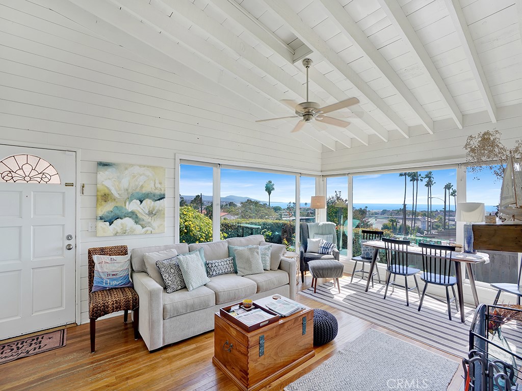 a living room with furniture a ceiling fan and a window