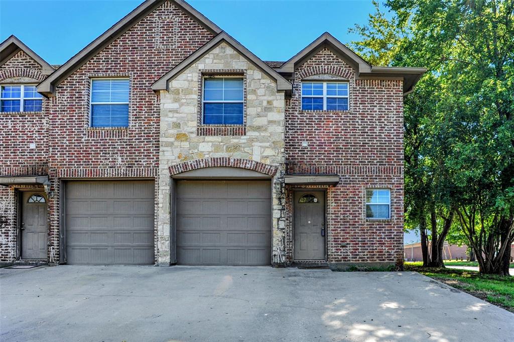 a front view of a house with garage