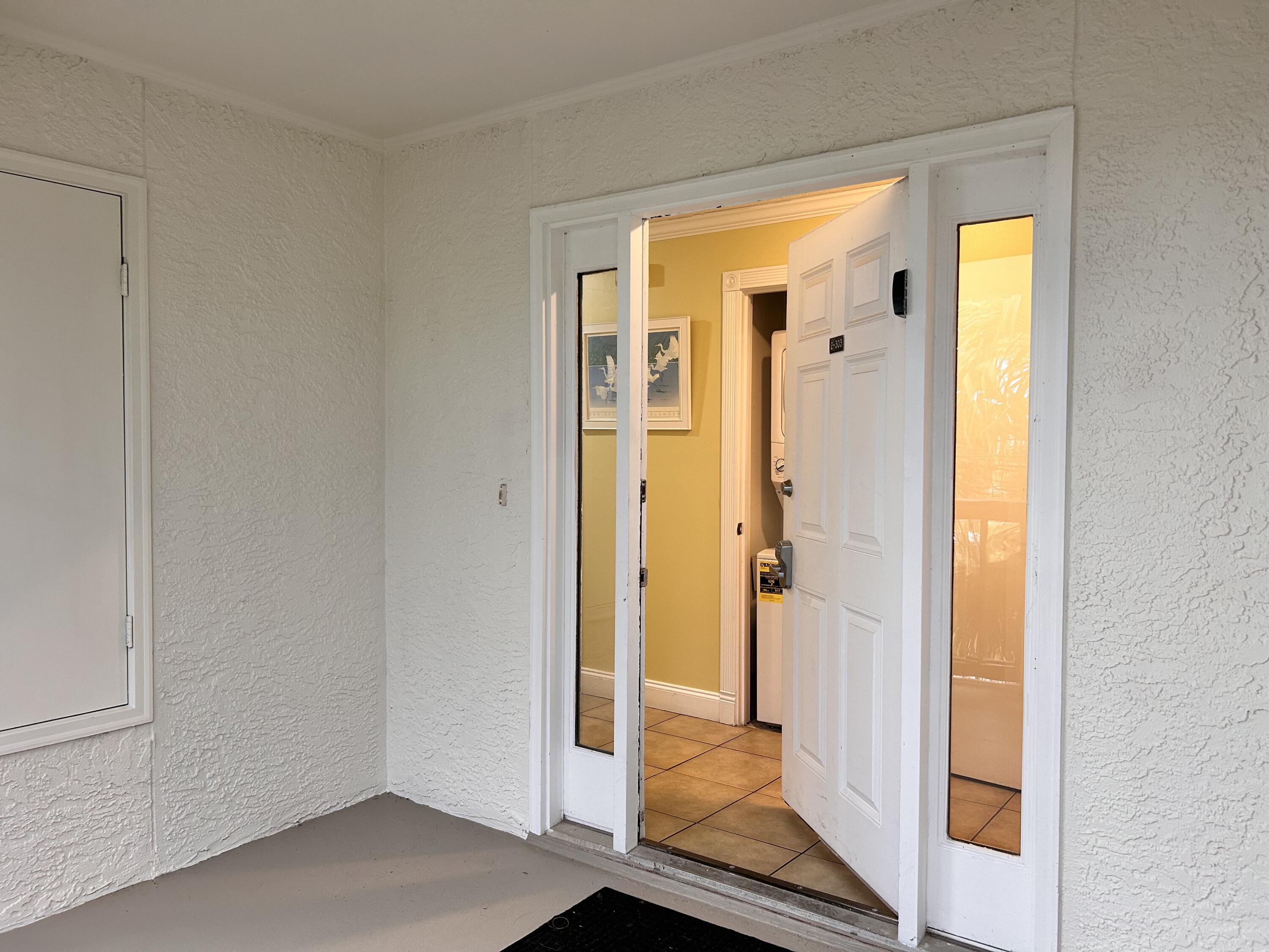 a view of a bathroom with wooden floor and glass door