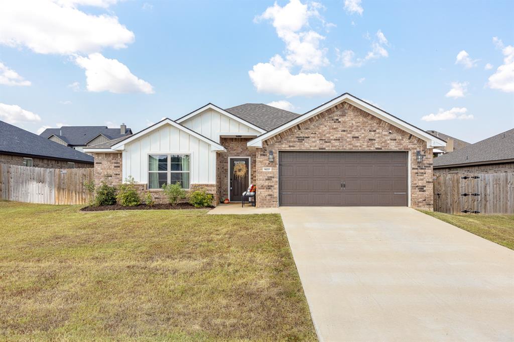 a view of a house with a yard and garage