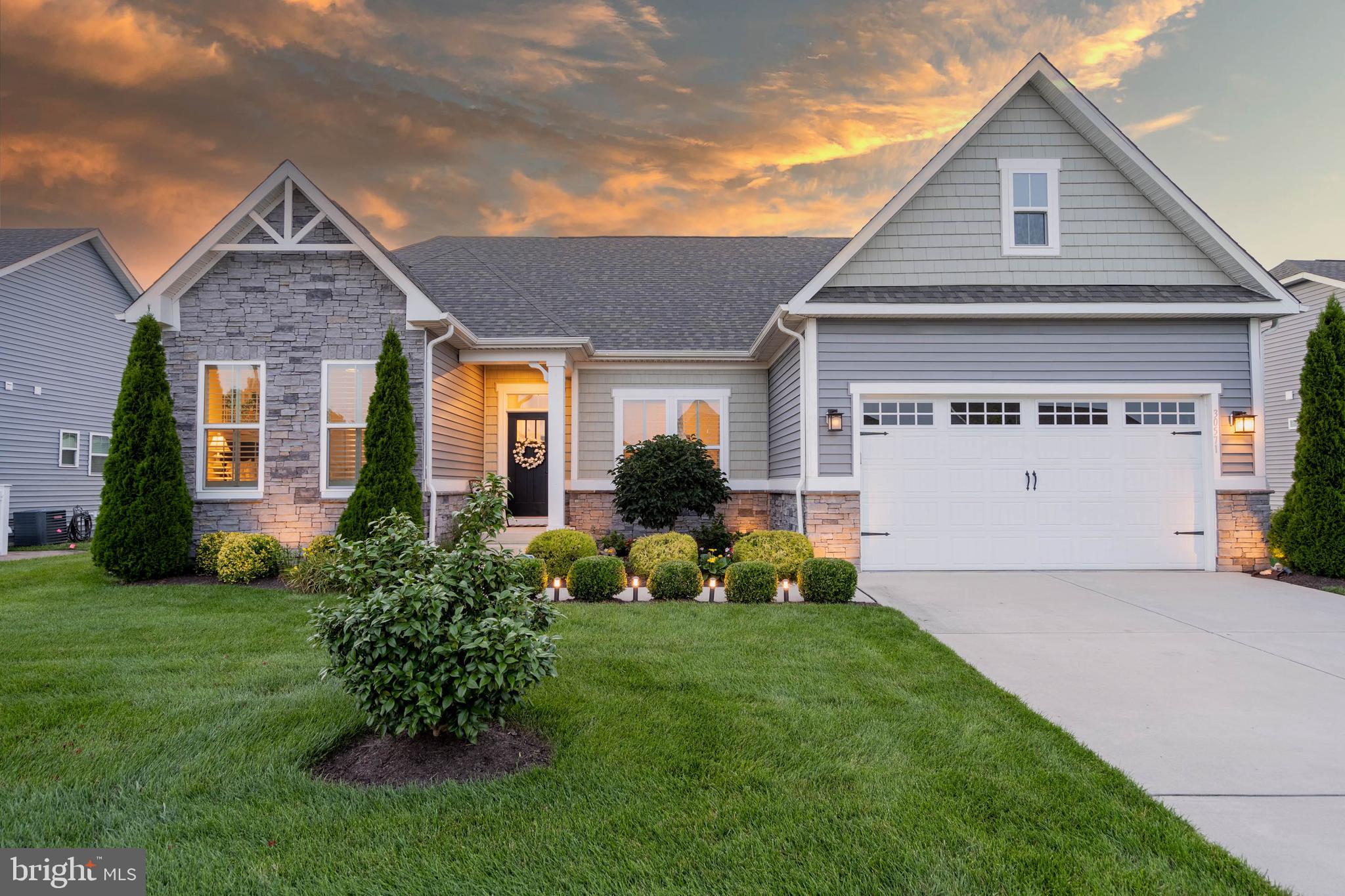 a front view of a house with garden