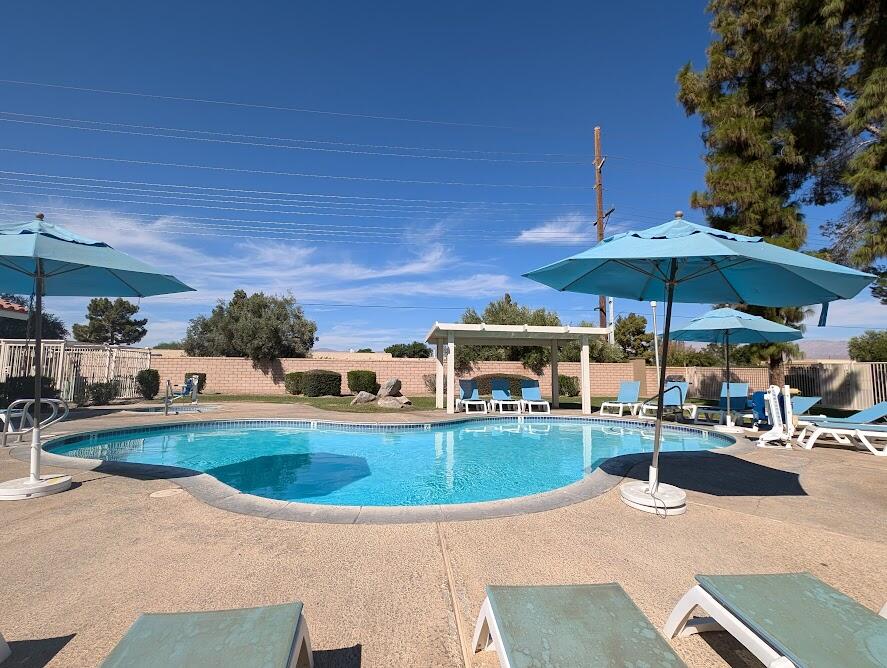 an outdoor space with pool and furniture