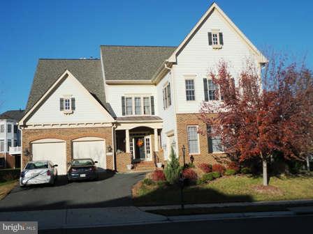 a view of a white house next to a yard