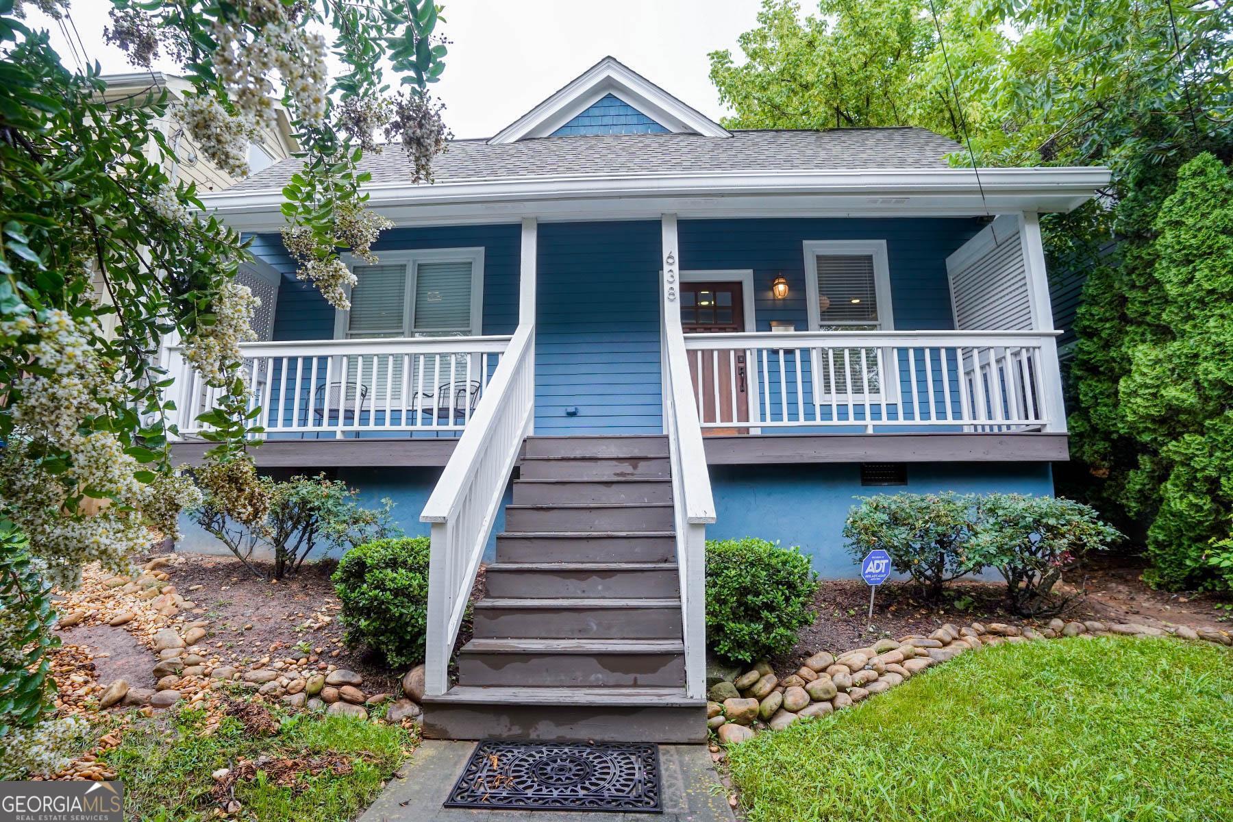 a view of a house with a window wooden deck and yard