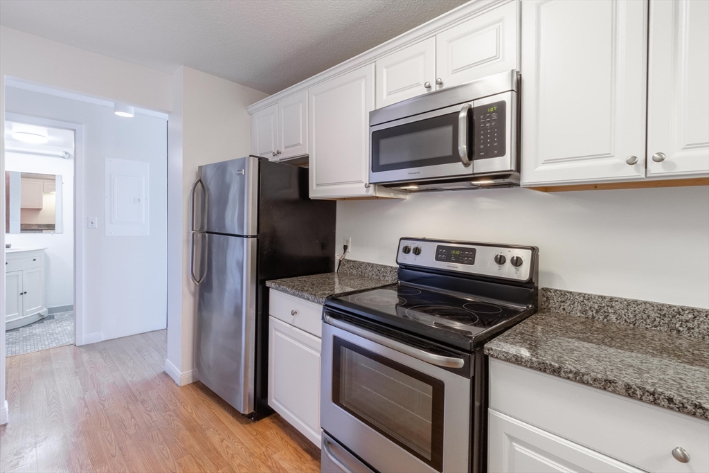 a kitchen with a stove microwave and refrigerator