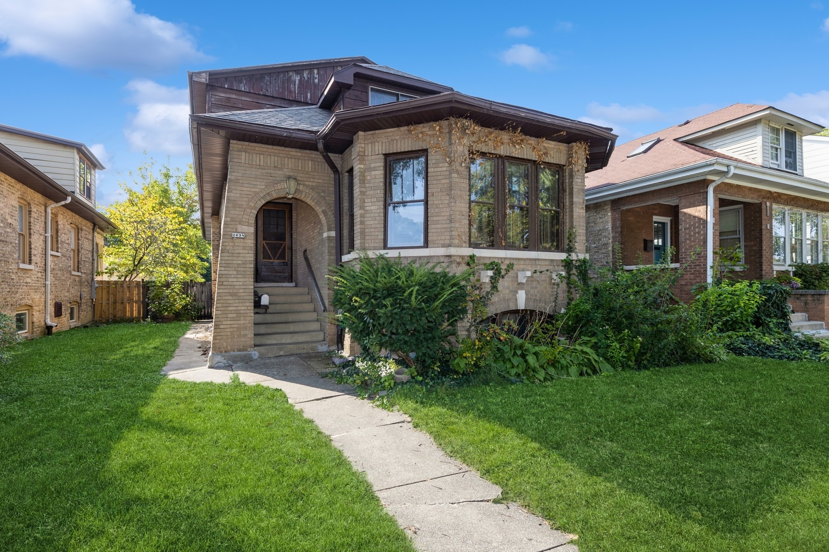 a front view of a house with a garden