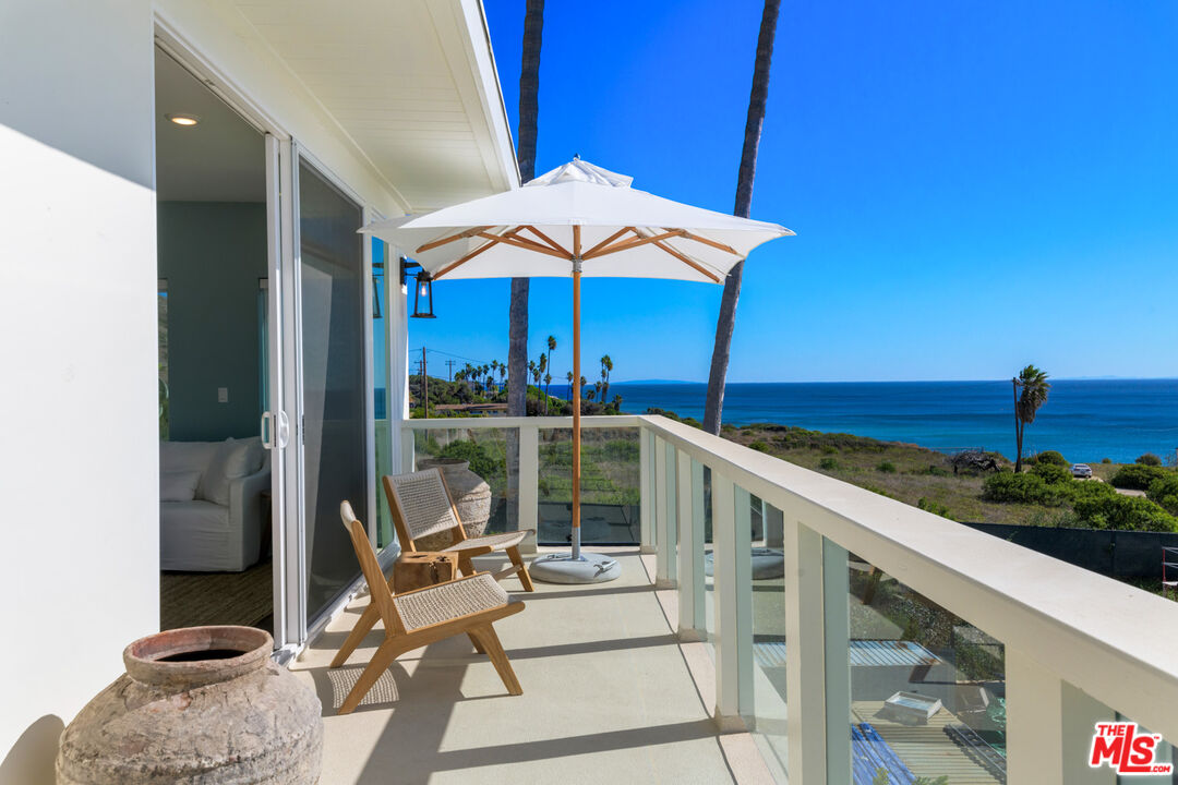 a view of a balcony with chair and table