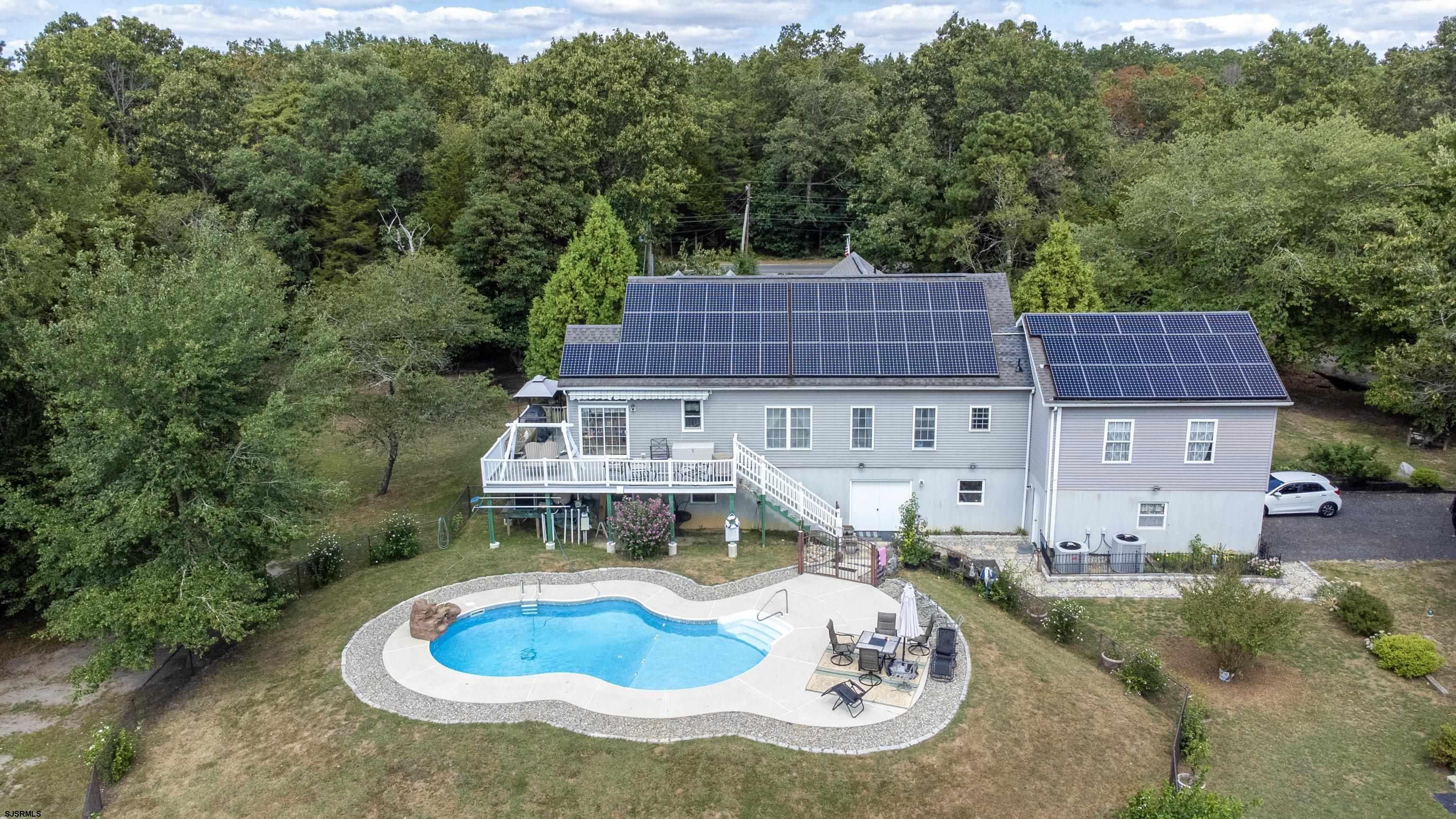 an aerial view of a house with outdoor space