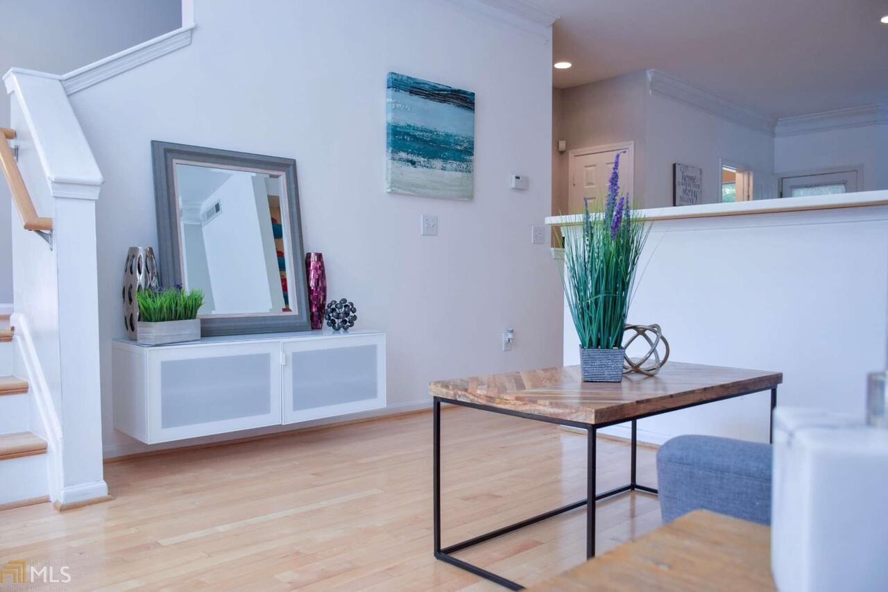 a view of a workspace living room with furniture and wooden floor