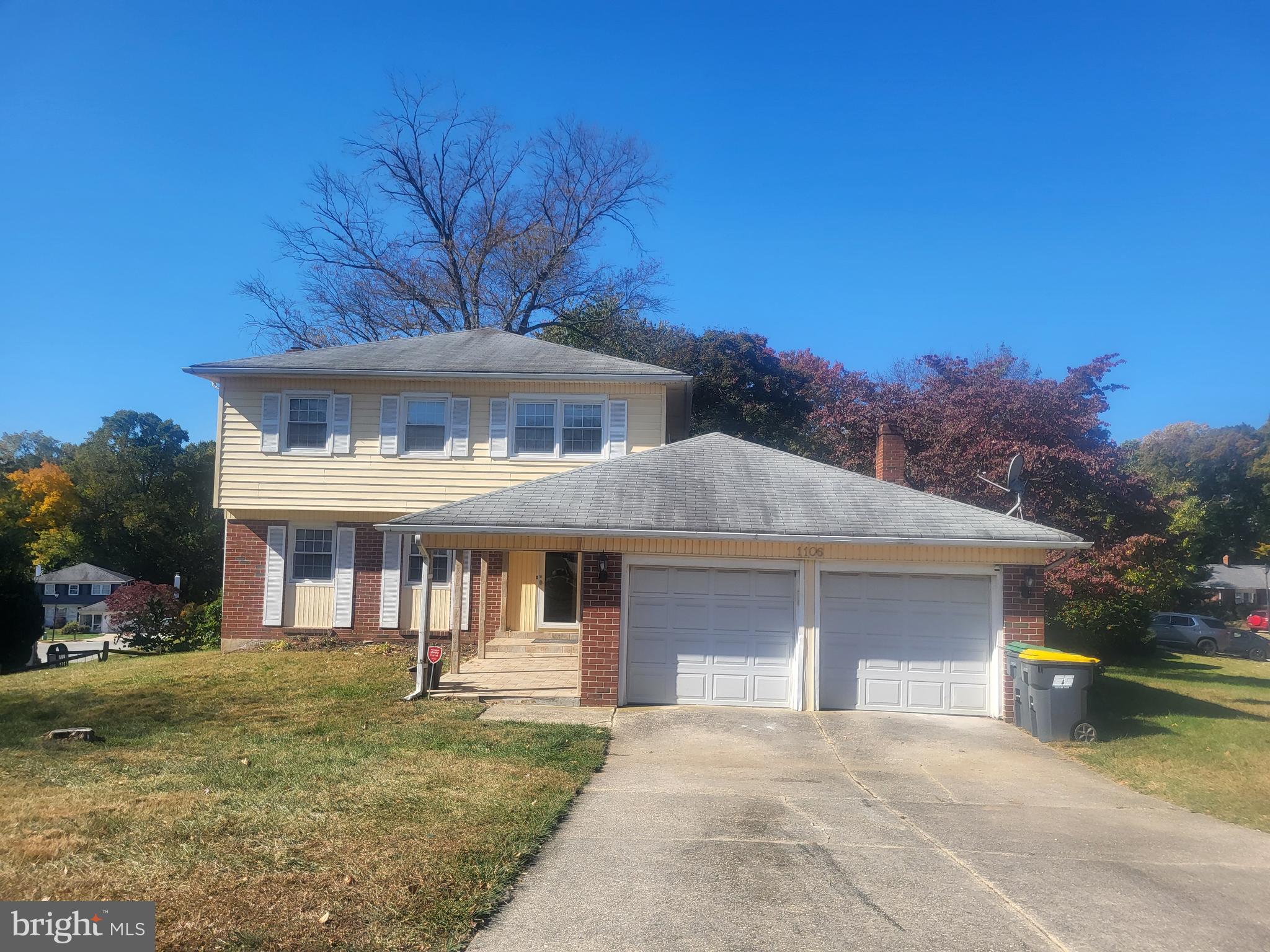 a front view of a house with a yard garage and outdoor seating