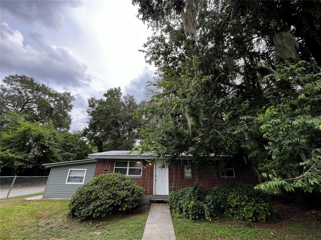 a view of house with yard