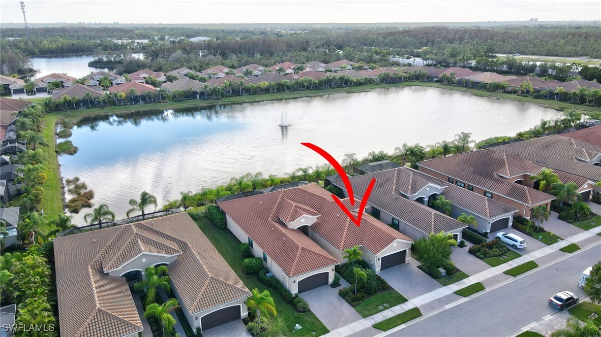 an aerial view of house with yard and lake view