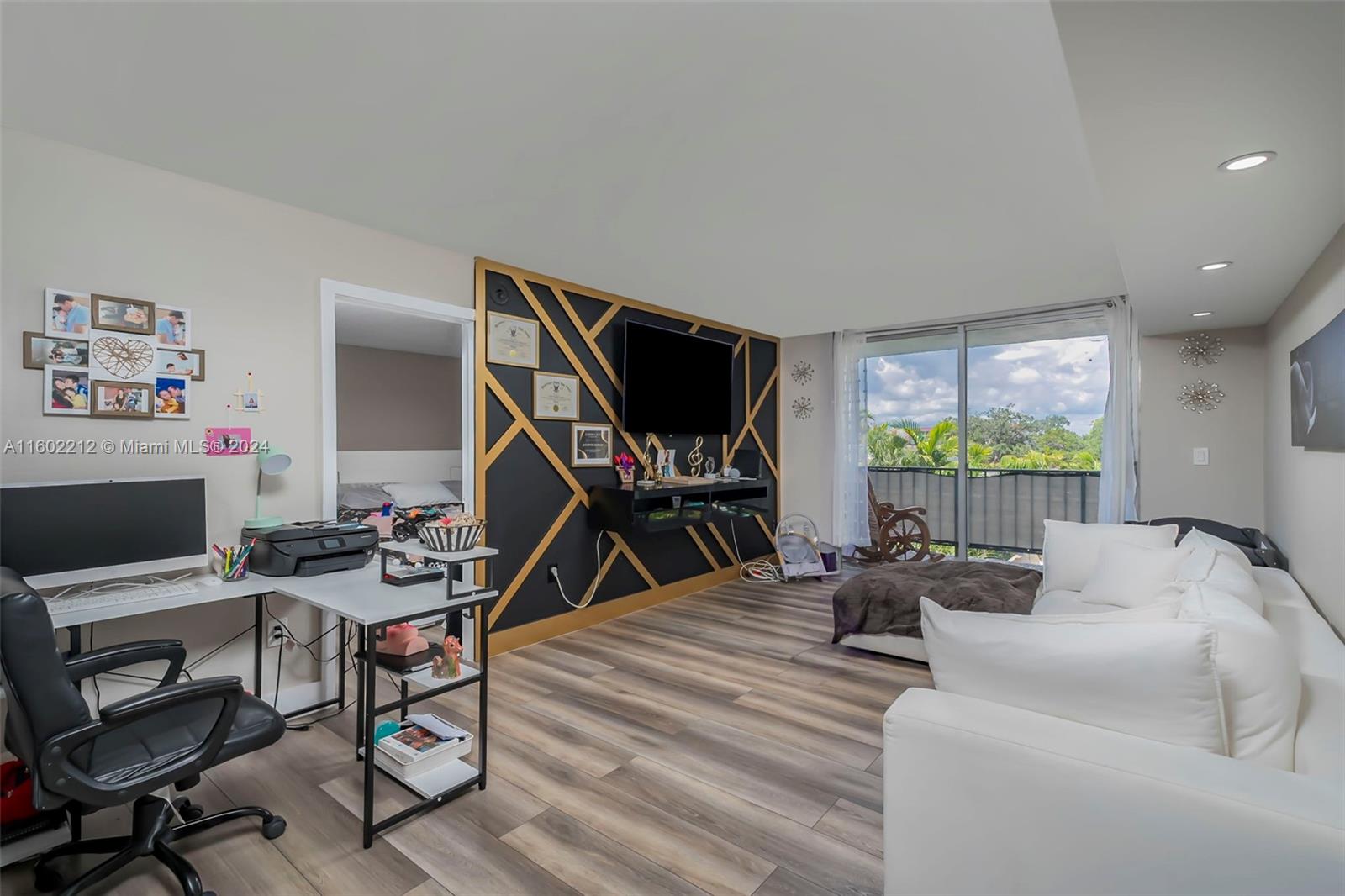 a workspace with furniture and a flat screen tv