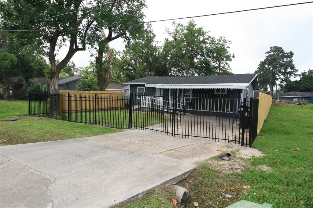 a view of a backyard with a garden and deck