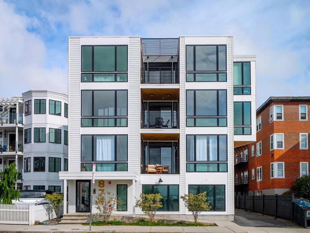 a front view of a residential apartment building with a yard