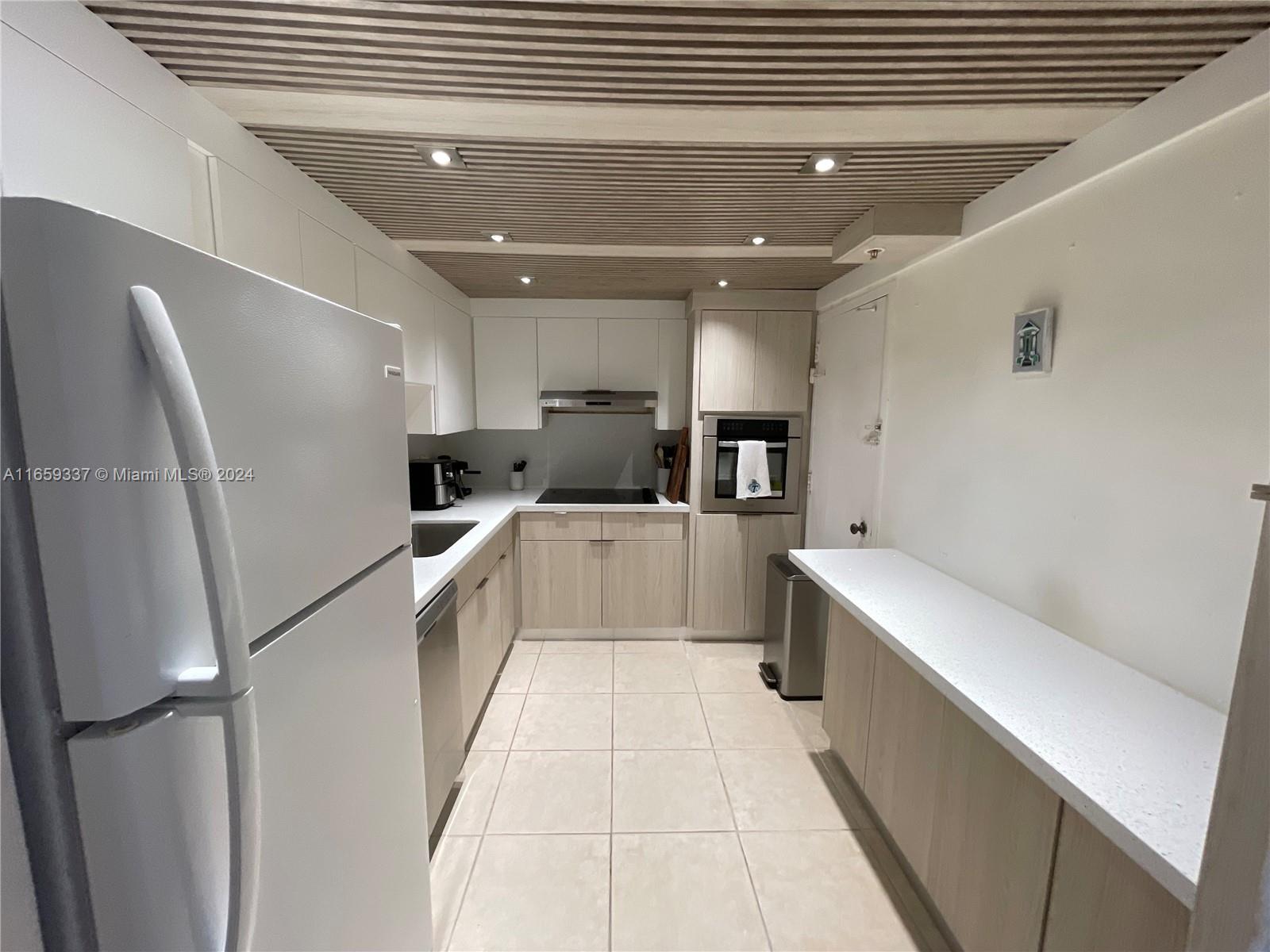 a kitchen with a refrigerator and a sink