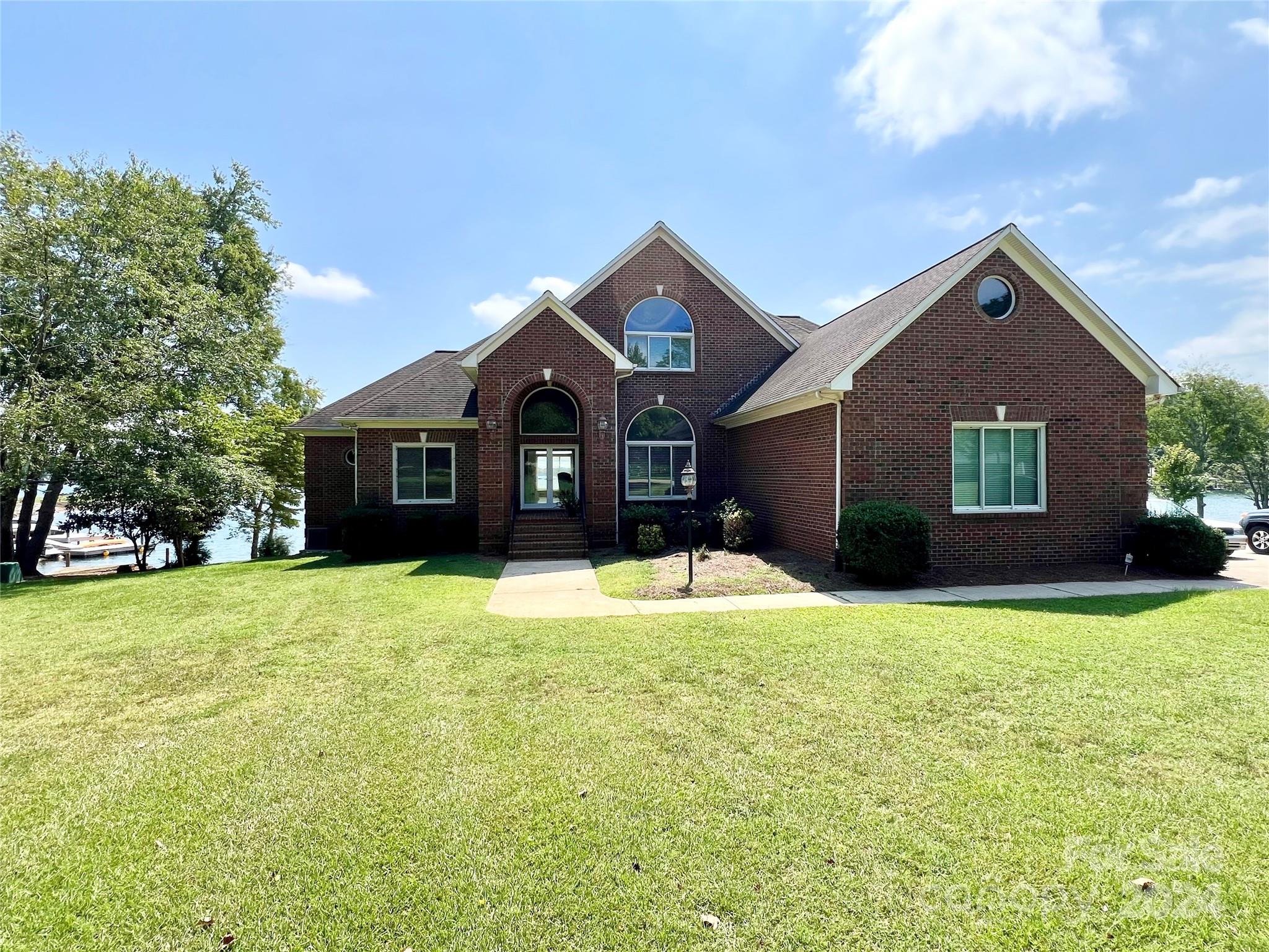 a front view of a house with yard and garage