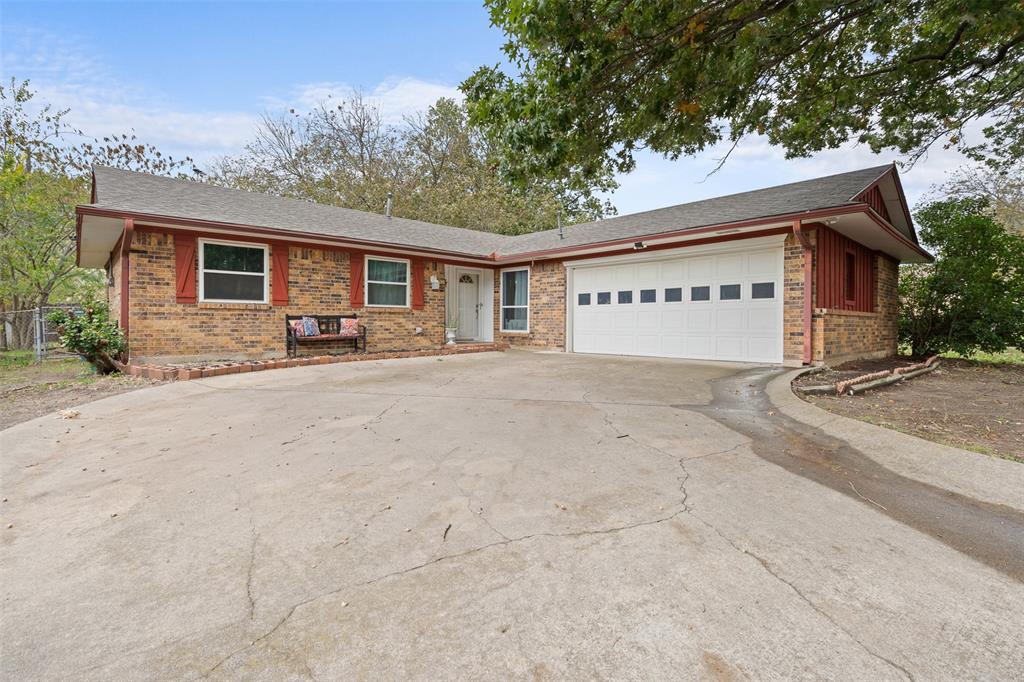 a view of a house with a yard and garage